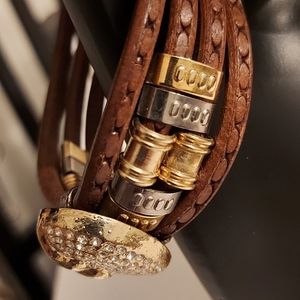 Gold tone metal and leather bracelet